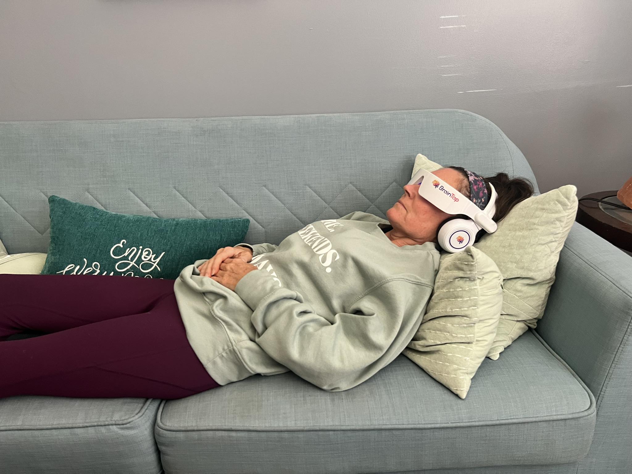 Client relaxing using the BrainTap headset � light stimulation, binaural beats, and guided audio combined