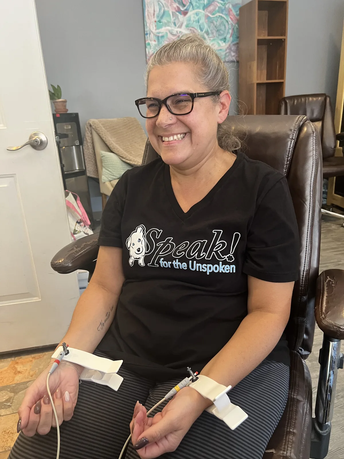 Client smiling during NeuralChek HRV assessment at Sweet Dreams Wellness